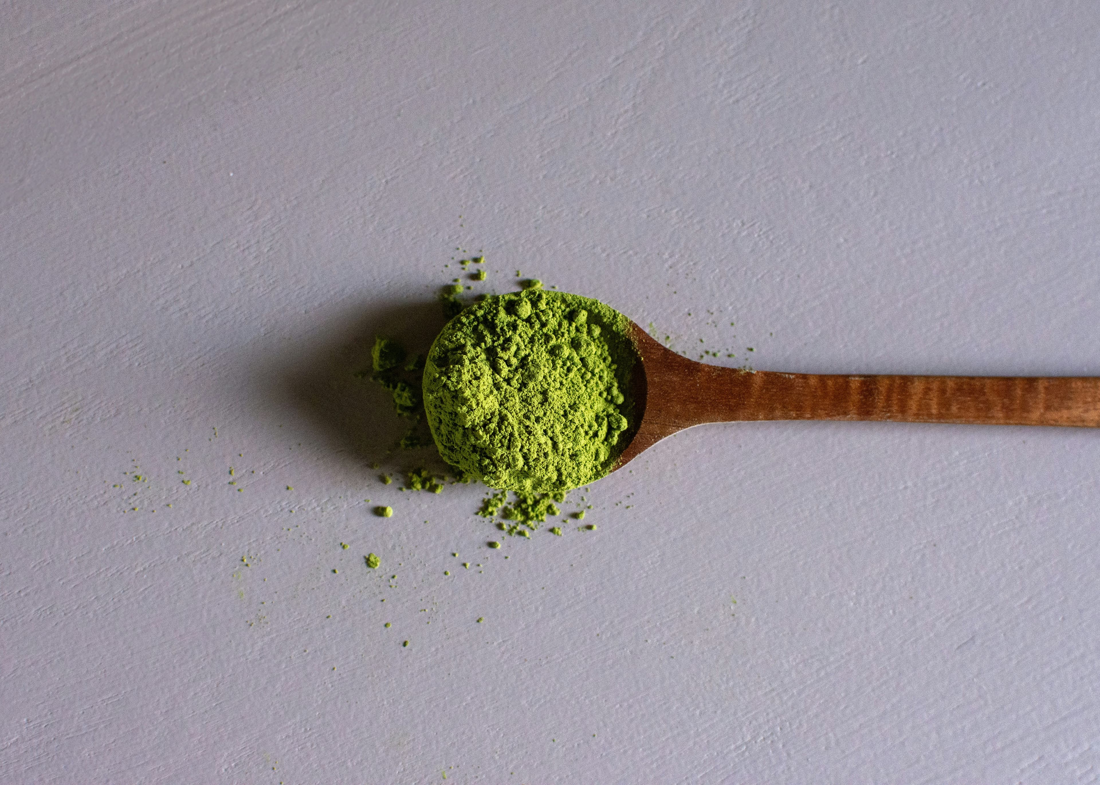 Matcha powder on a wooden spoon
